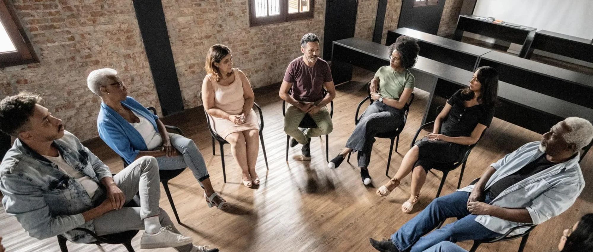 A group of adults getting outpatient cocaine addiction treatment through a group therapy session at Renova Behavioral Health, a rehab center in Peabody, MA.