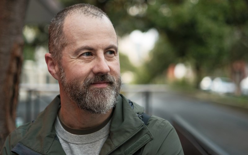 man in his 40s looking self-confident and happy