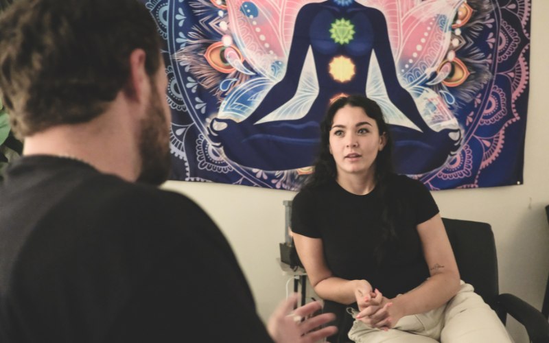 Therapist and young male client in session for addiction therapy
