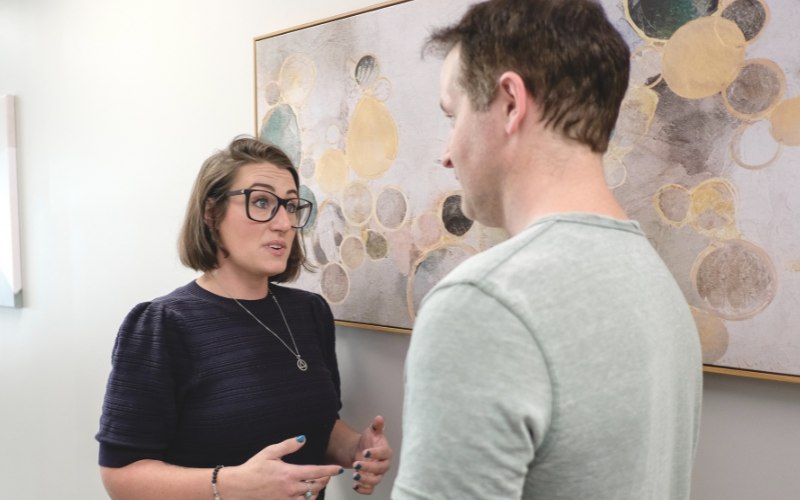 two therapists discussing a client being treated for addiction